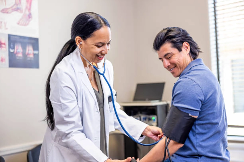 Provider checking blood pressure